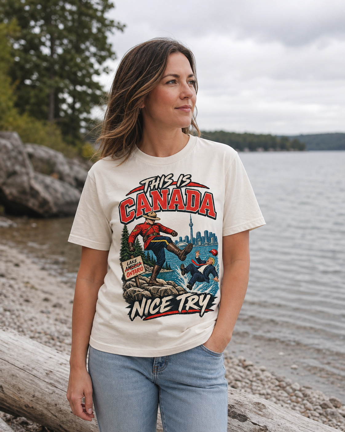 Cream | Model wearing the This is Canada graphic tee on the Lake Ontario shore, front view.