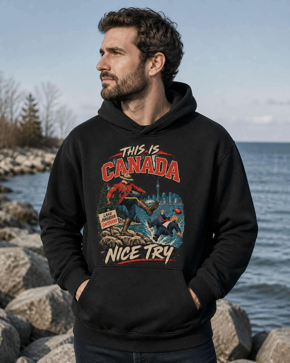 Coal | Model wearing the This is Canada hoodie on the Lake Ontario shore, front view.
