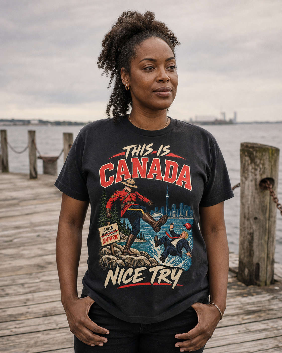 Coal | Model wearing the This is Canada graphic tee on a Lake Ontario pier, front view.