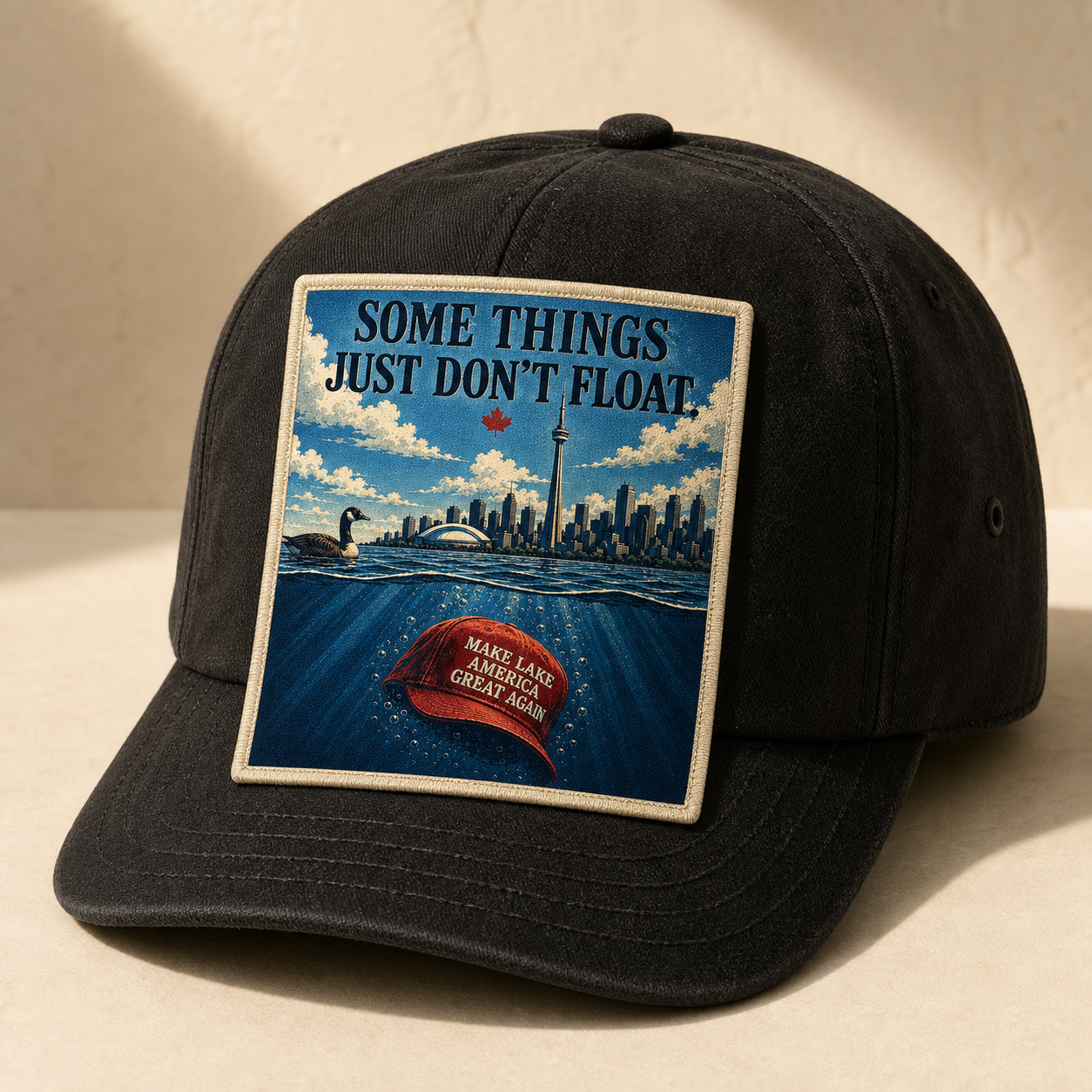 Some Things Just Don't Float artwork on a coal hat with a woven front patch.